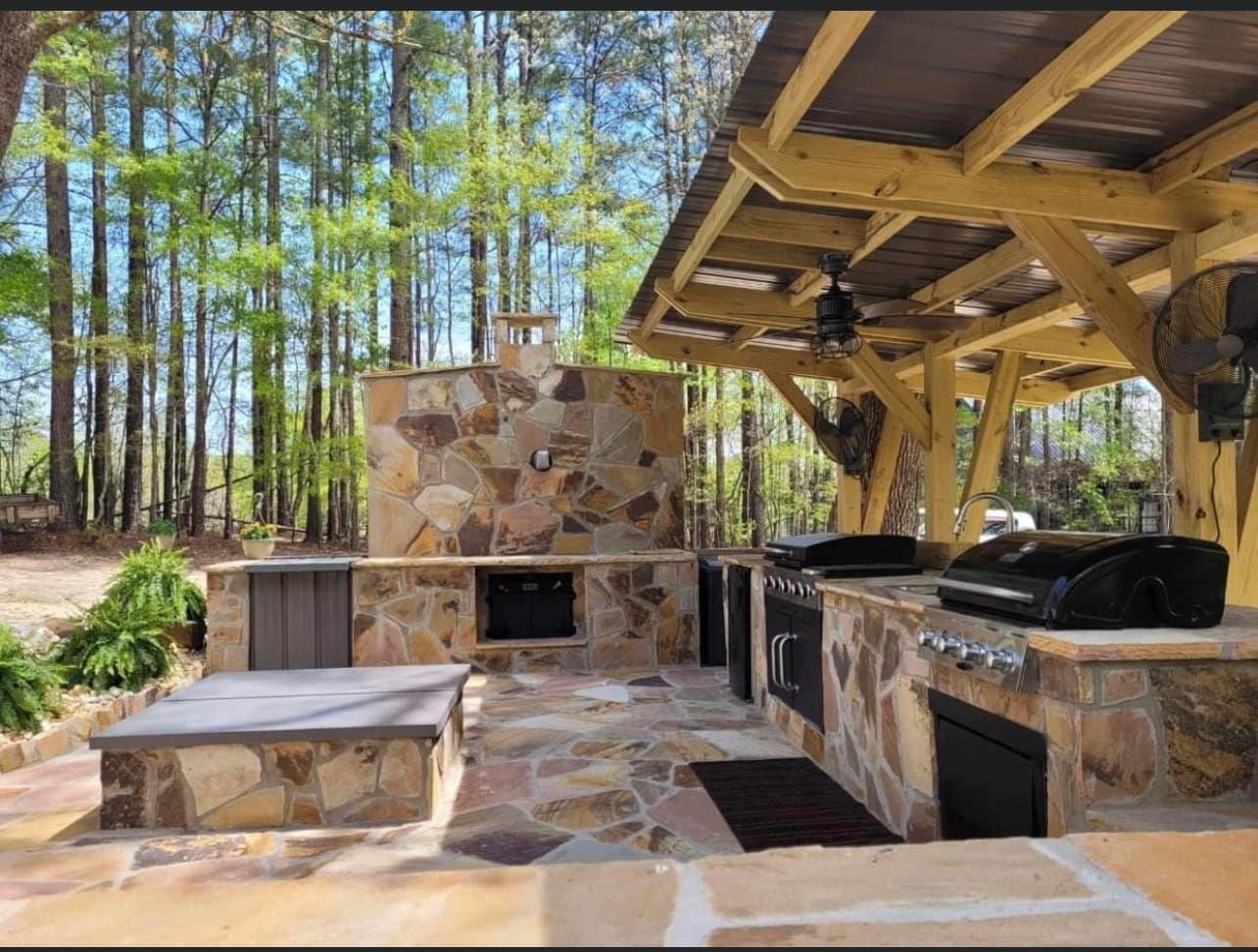 Stone outdoor kitchen under a pavilion