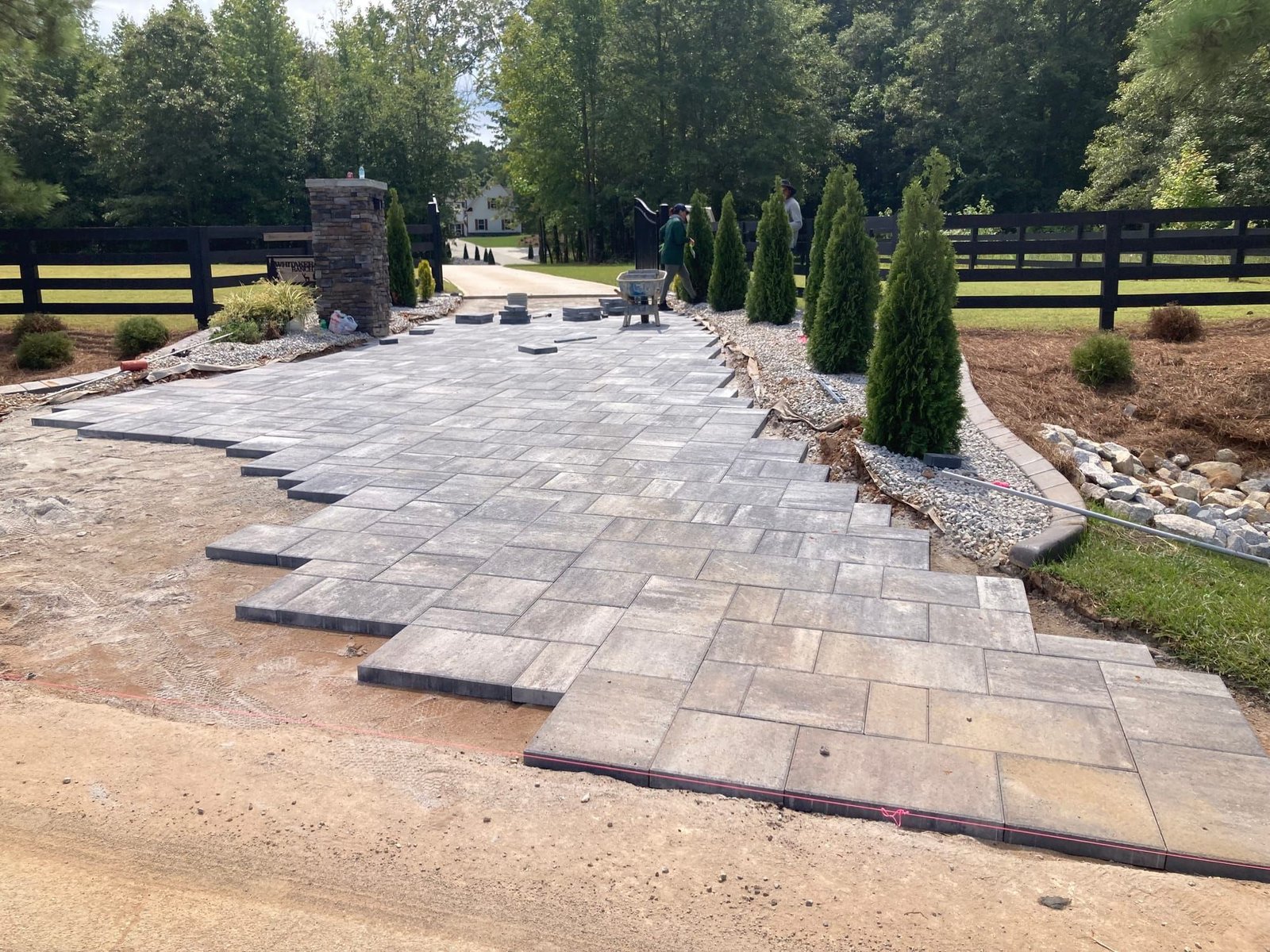 Large backyard paver patio installed by Reliable Hardscapes